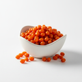 Wild-harvested sea buckthorn dry berries in a ceramic bowl on white background